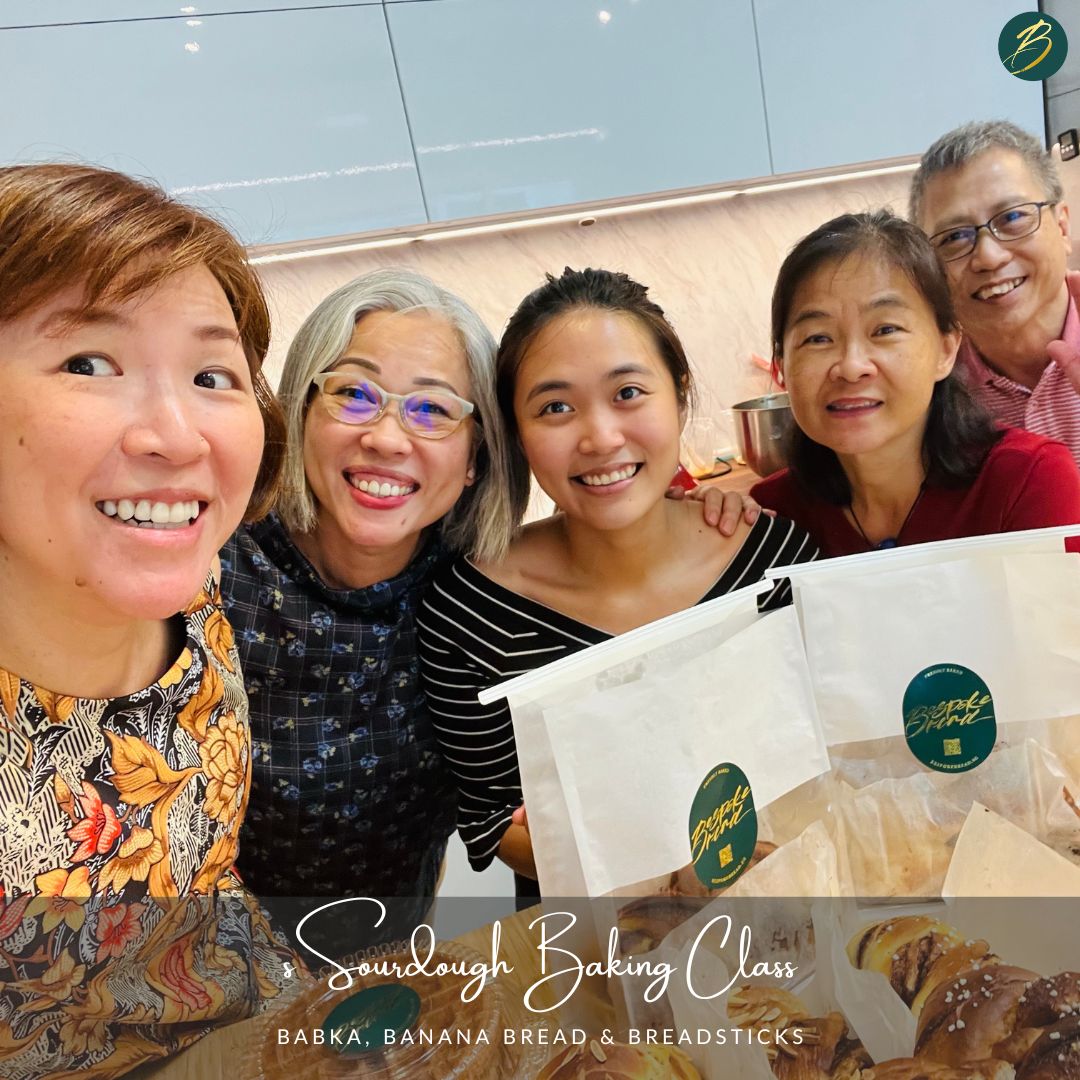 group of women smiling with banana bread and breadsticks