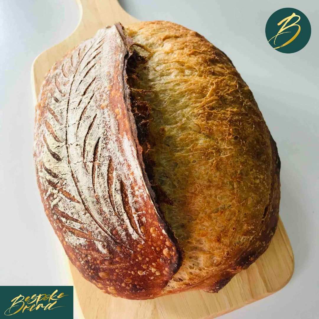 Close-up of a round sourdough bread loaf with a crunchy crust and chewy interior