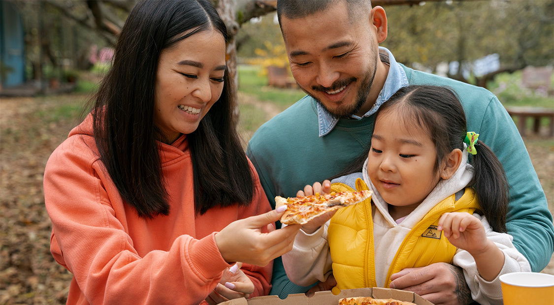 a group of family sharing pizza