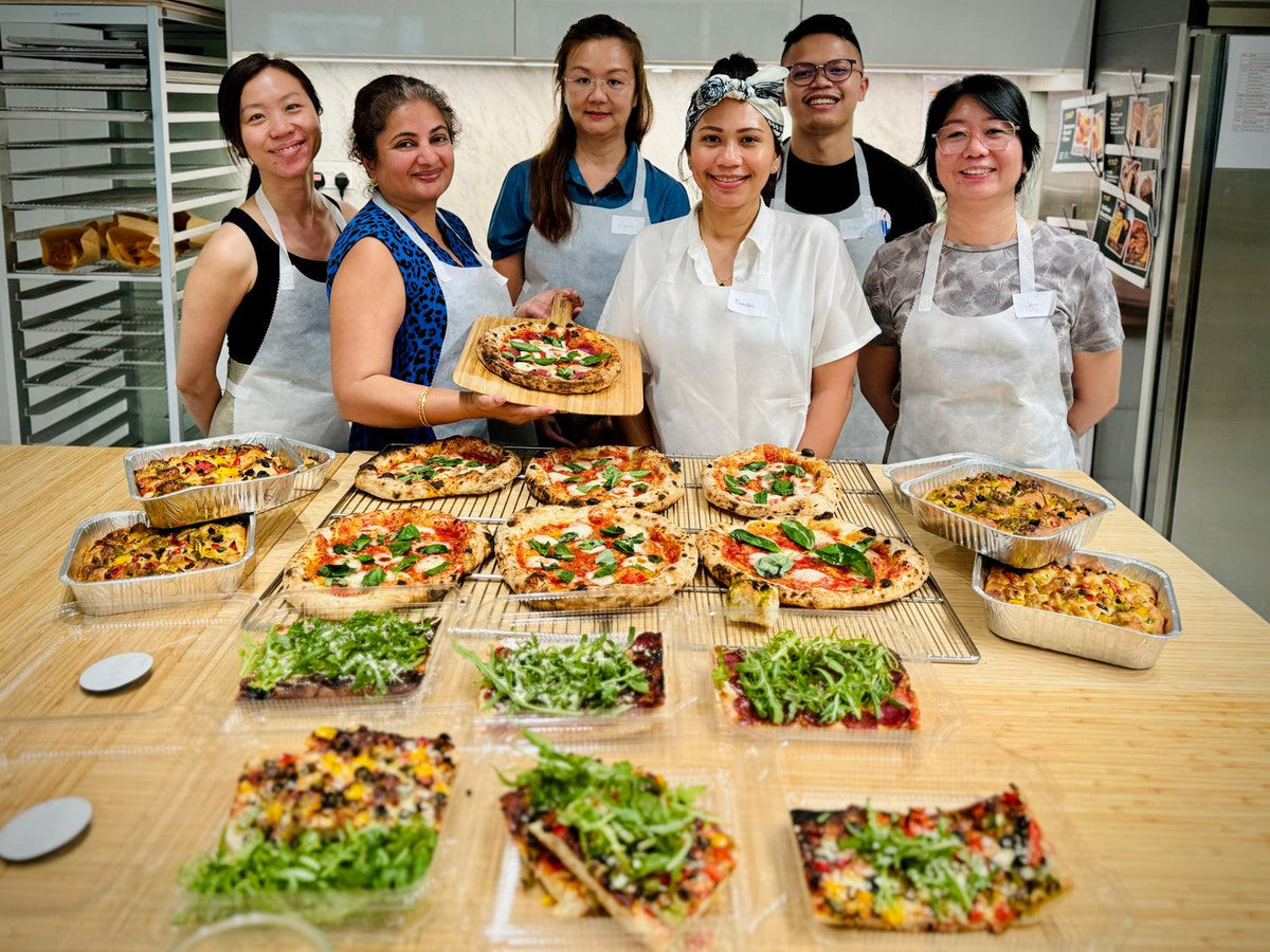 Group enjoying an interactive artisan bread class in Singapore for corporate team building