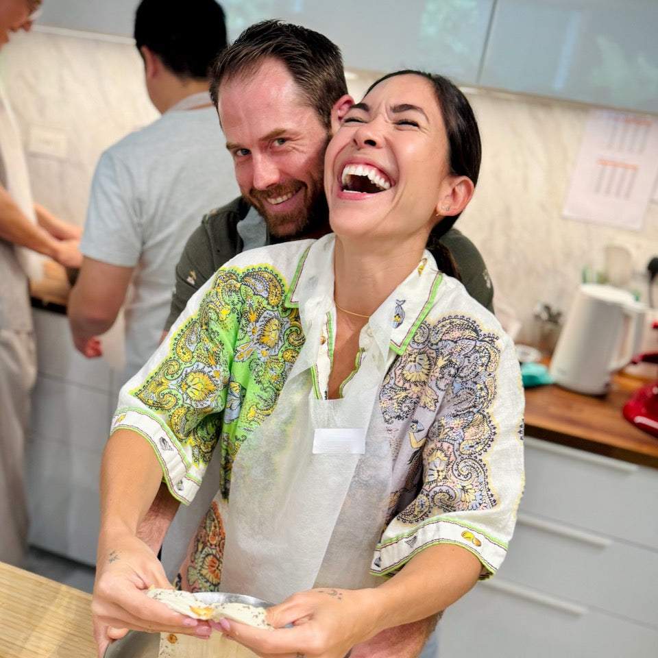 Couple enjoying a hands-on baking class together in Singapore kitchen