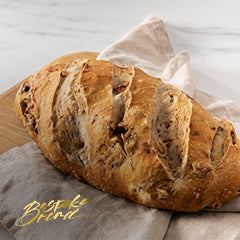 Close-up of sourdough bread with cracks and uneven crumb highlighting common sourdough bread problems troubleshooting steps