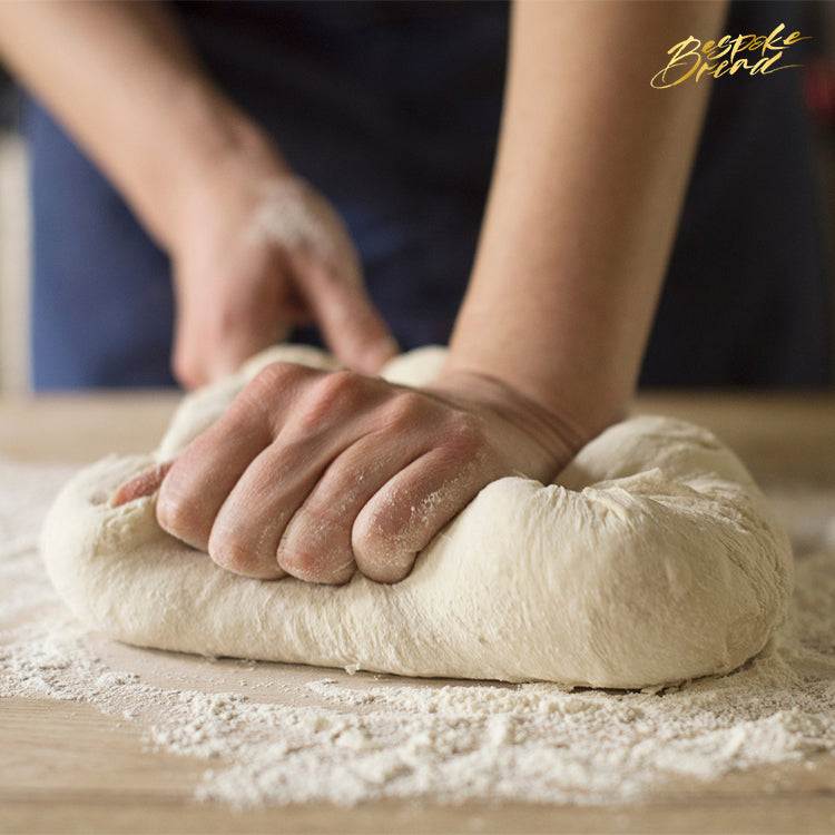 Hand kneading dough during a bread making class for mental well-being and mindfulness