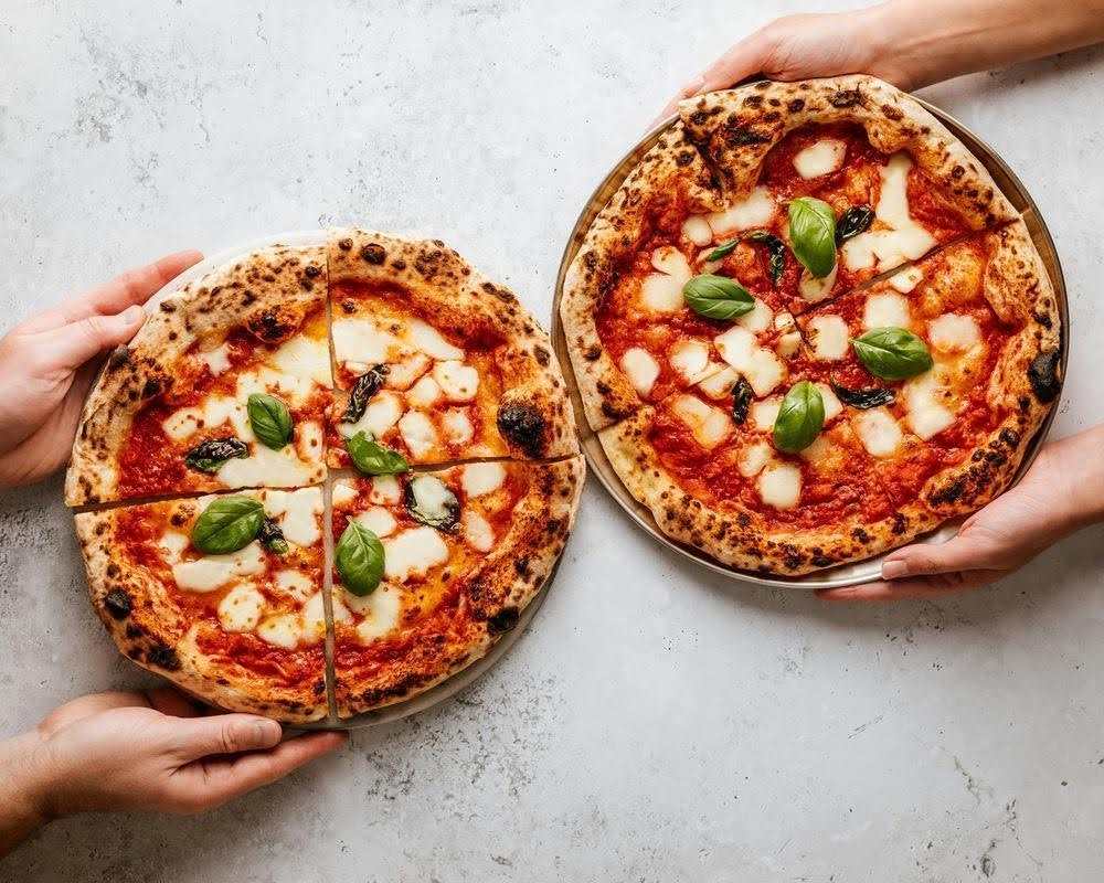 Authentic Neapolitan pizza with thin crust, fresh mozzarella, basil, and wood-fired charred edges