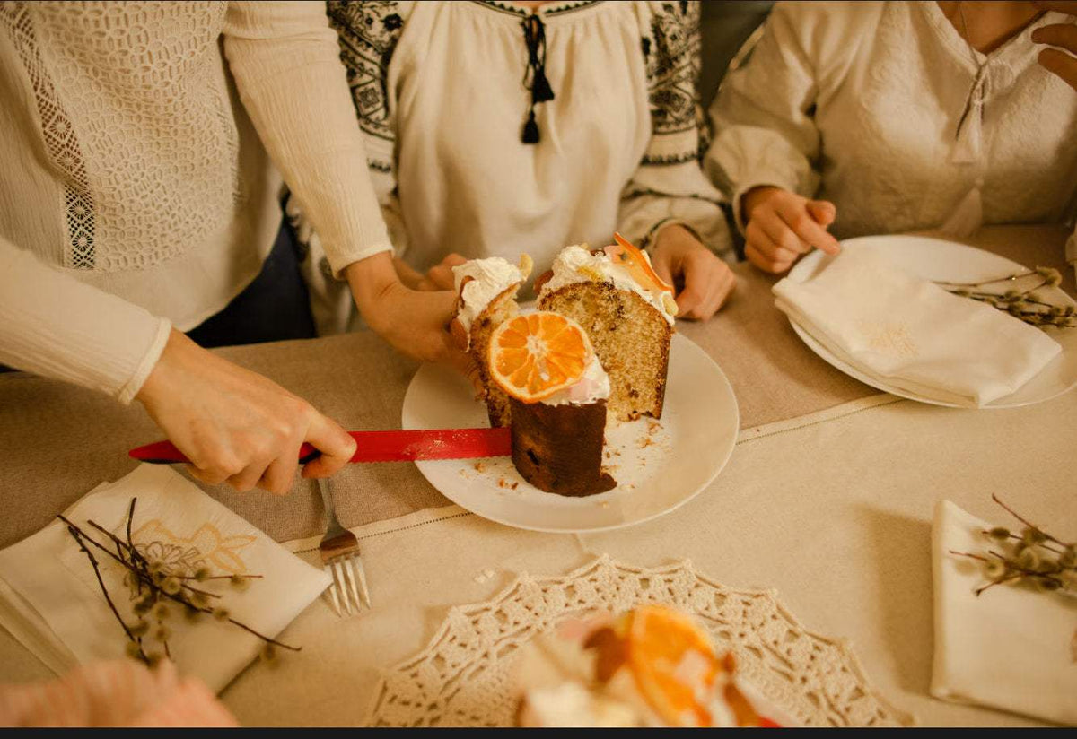 Slice of tall, fluffy Italian panettone bread on a wooden board, showcasing its light, airy texture in this panettone guide.