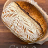 Participants learning hands-on sourdough baking techniques in a small class setting