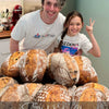 Participants shaping sourdough bread during a hands-on sourdough baking class session